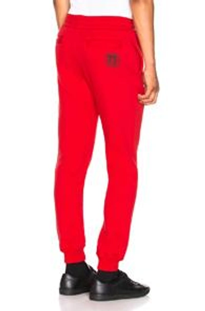 Shop Versace Sweatpants In Red. In Red & Black