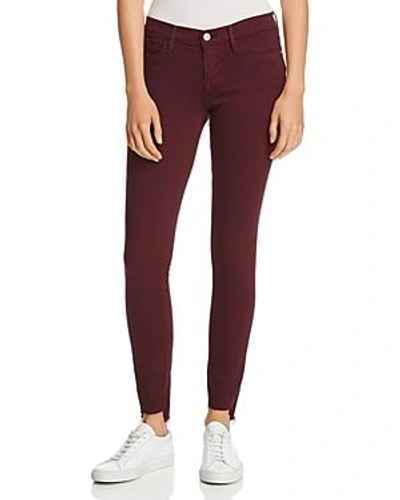 Shop Frame Le Skinny De Jeanne Raw-edge Stagger Jeans In Pinot