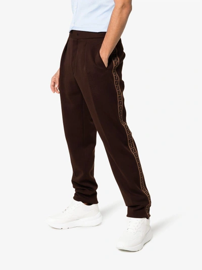 Shop Fendi Ff Ticker Tape Logo Trousers In Brown
