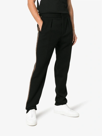 Shop Fendi Ff Ticker Tape Logo Trousers In Black