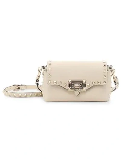 Shop Valentino Mini Rockstud Leather Crossbody Bag In Poudre