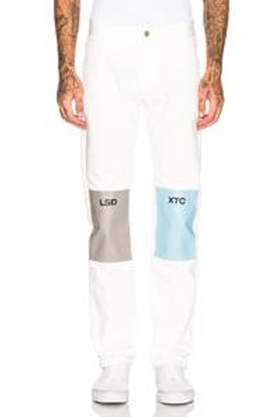 Shop Raf Simons Regular Fit Jean With Patches In White. In Cream & Grey