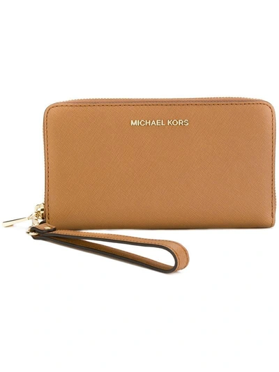 Shop Michael Michael Kors Wrist Strap Zip Wallet In Brown