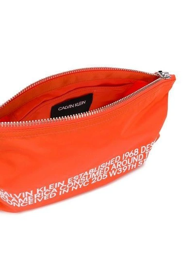 Shop Calvin Klein 205w39nyc Embroidered Text Clutch Bag - Orange