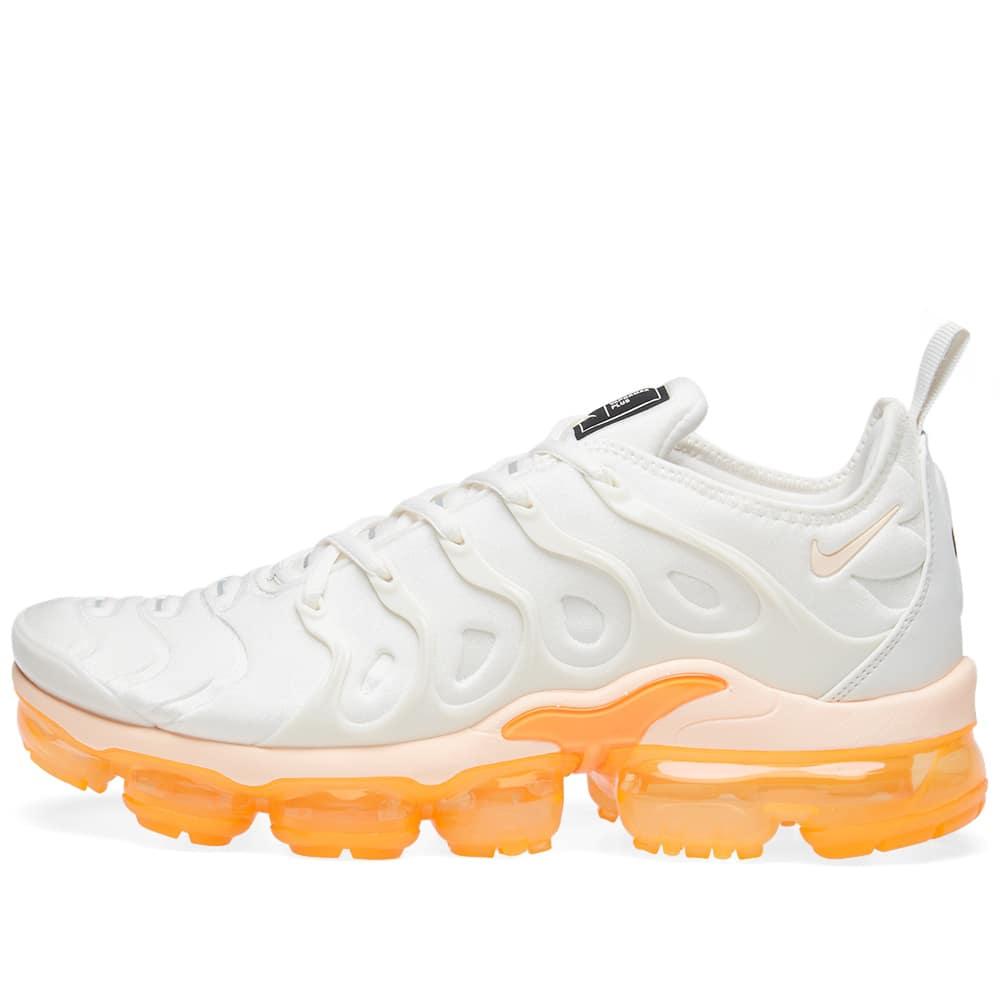 white and orange vapormax plus