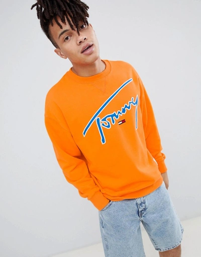 Shop Tommy Jeans Signature Capsule Logo Front Sweatshirt Relaxed Fit In Orange - Orange
