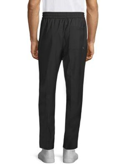 Shop Etudes Studio Jalousie Tapered Trousers In Black