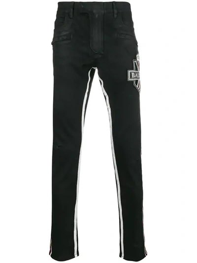 Shop Balmain Embellished Logo Jeans In Black