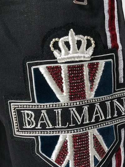 Shop Balmain Embellished Logo Jeans In Black