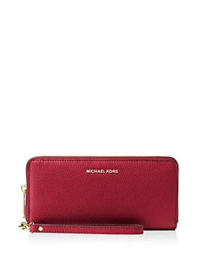 Shop Michael Michael Kors Mercer Travel Continental Wallet In Maroon Red/gold