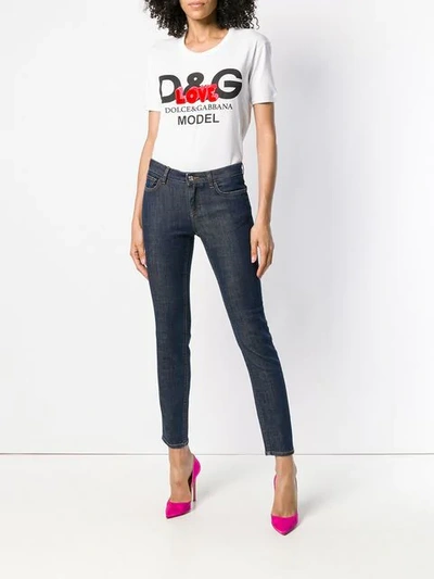 Shop Dolce & Gabbana Rear-slogan Skinny-fit Jeans In Blue