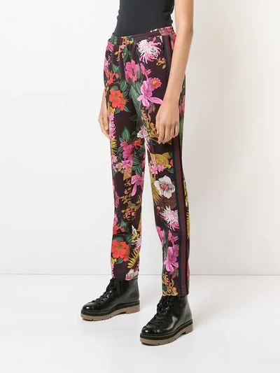 Shop Moncler Floral Print Trousers In Red