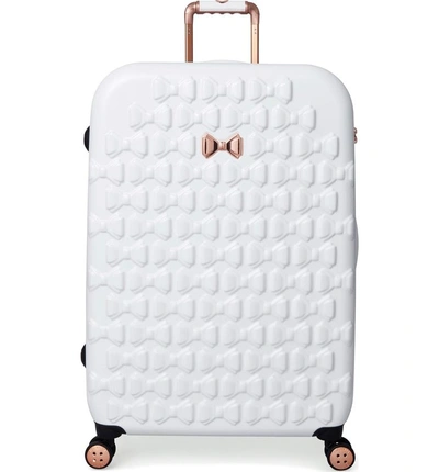 Shop Ted Baker Large Beau Bow Embossed Four-wheel 31-inch Trolley Suitcase - White
