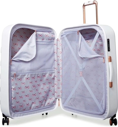 Shop Ted Baker Large Beau Bow Embossed Four-wheel 31-inch Trolley Suitcase - White