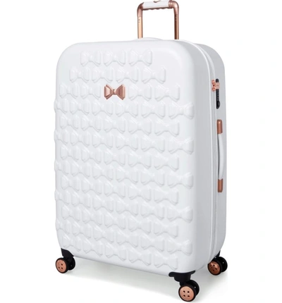 Shop Ted Baker Large Beau Bow Embossed Four-wheel 31-inch Trolley Suitcase - White