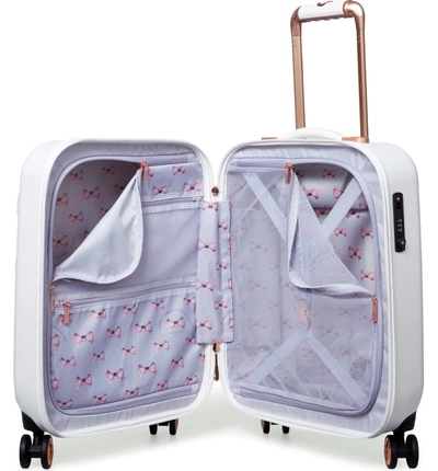 Shop Ted Baker Small Beau 21-inch Bow Embossed Four-wheel Trolley Suitcase - White