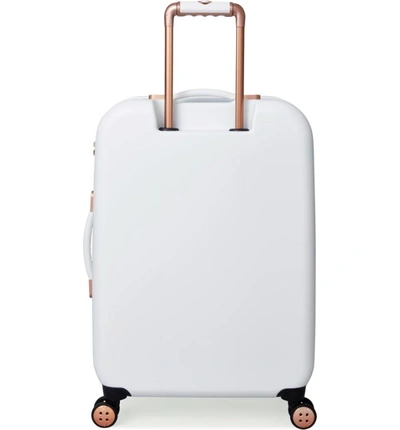 Shop Ted Baker Medium Beau Bow Embossed Four-wheel 27-inch Trolley Suitcase - White