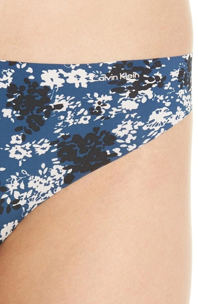 Shop Calvin Klein Invisibles Thong In Simple Floral/ Lyria Blue