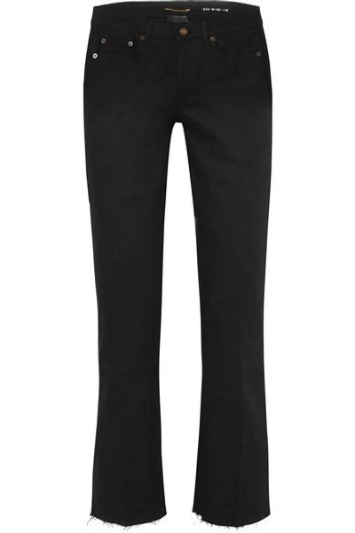 Shop Saint Laurent Cropped Frayed Low-rise Flared Jeans In Black