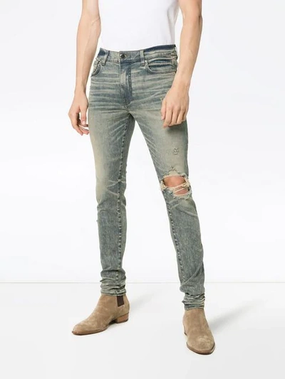 Shop Amiri Distressed Skinny Jeans In Blue