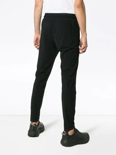 Shop Satisfy Justice Run Logo Printed Trousers In Black