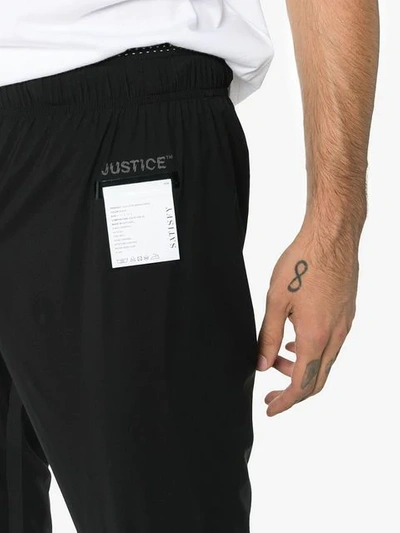 Shop Satisfy Justice Run Logo Printed Trousers In Black