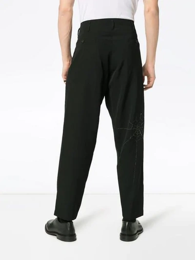 Shop Yohji Yamamoto Spiderweb Printed Wool Trousers - Black