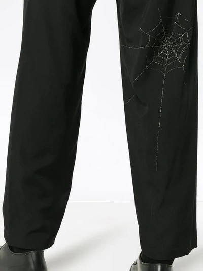 Shop Yohji Yamamoto Spiderweb Printed Wool Trousers - Black