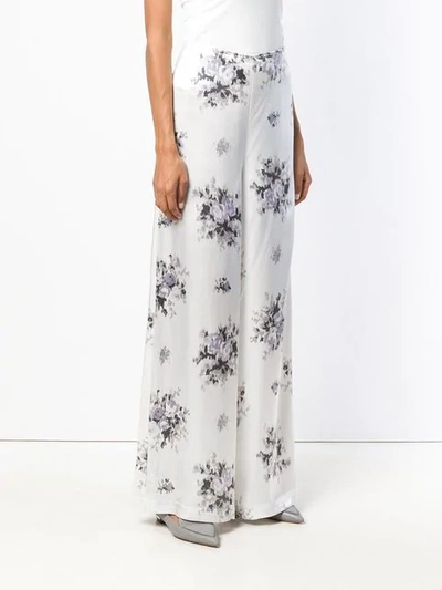 Shop Ganni Floral Print Trousers In White