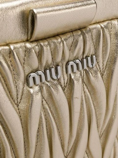 Shop Miu Miu Quilted Logo Clutch Bag - Metallic