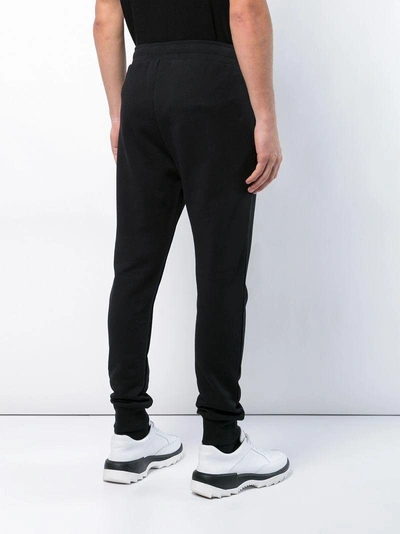Shop Moschino Logo Track Pants - Black