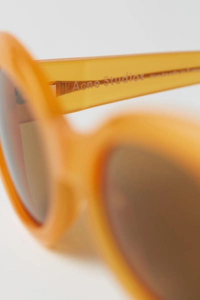 Shop Acne Studios Oval Sunglasses Orange/brown