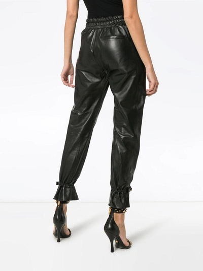 Shop Skiim Gaby High-waisted Leather Track Pants - Black