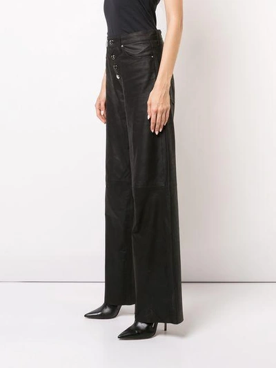 Shop Amiri Wide-leg Trousers - Black