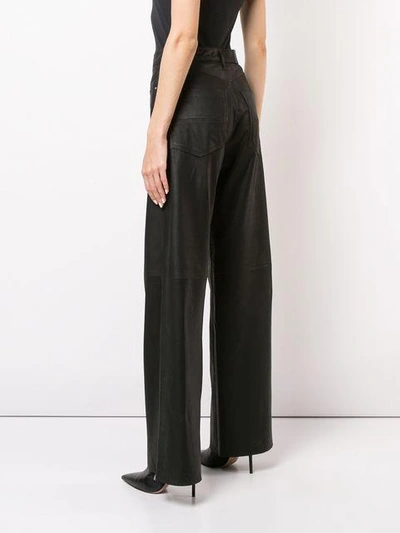 Shop Amiri Wide-leg Trousers - Black