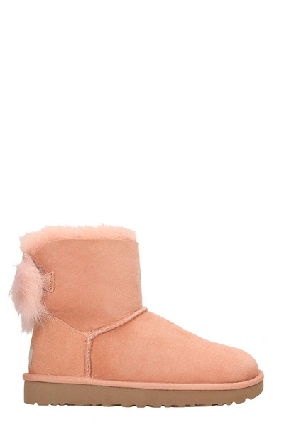 Shop Ugg Fluff Mini Bow Boots In Rose-pink