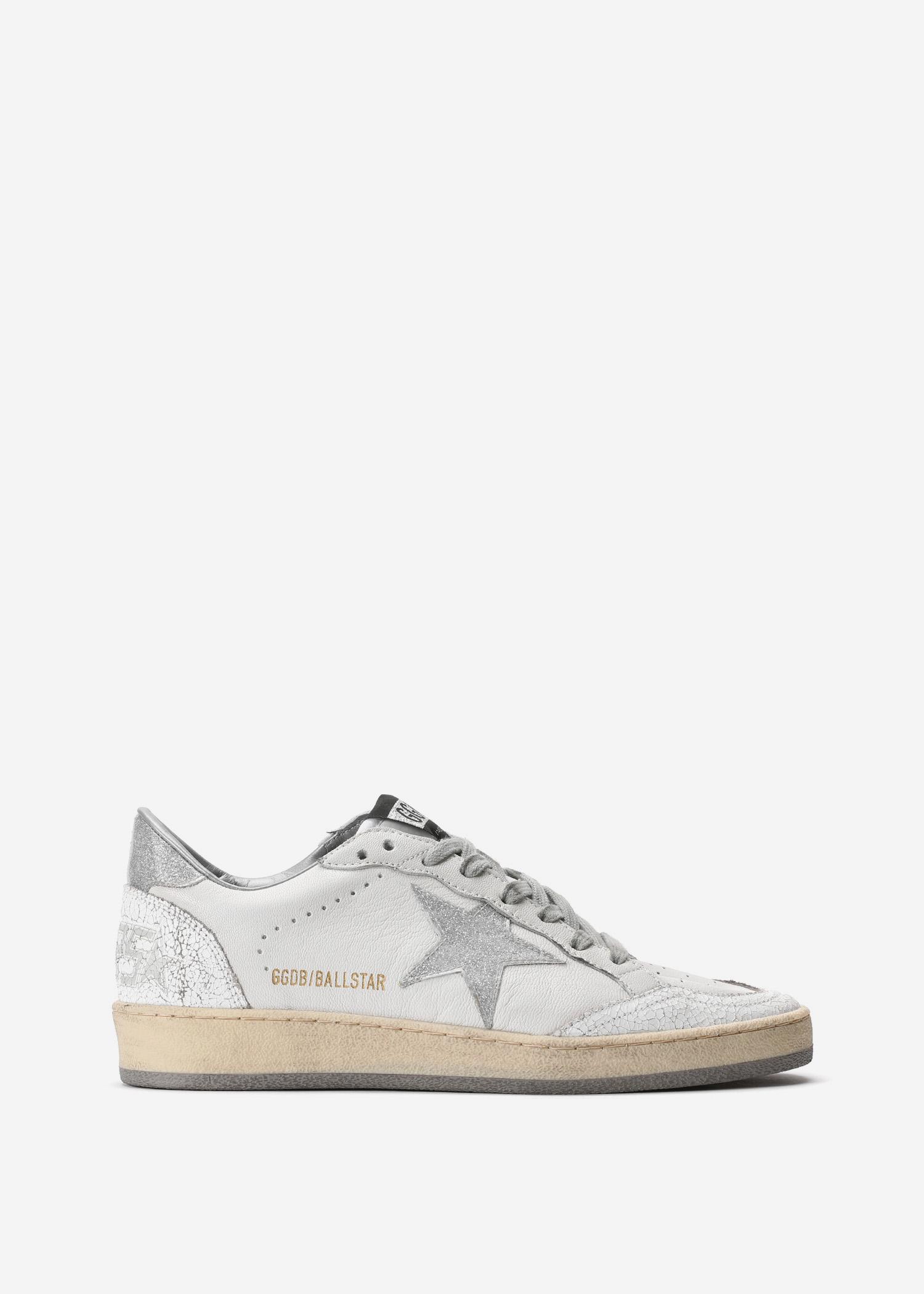 white and silver golden goose sneakers