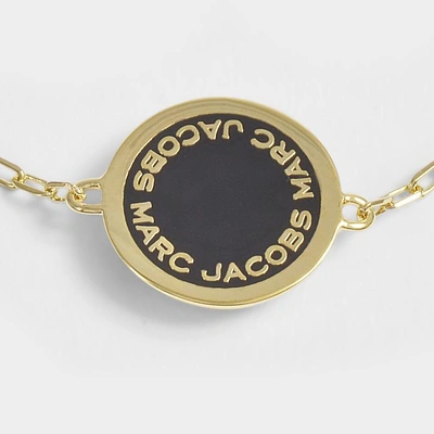 Shop Marc Jacobs Logo Disc Bracelet In Black And Gold Brass - Jewelry Us