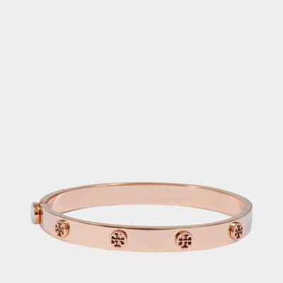 Shop Tory Burch Logo Stud Hinge Bracelet In Gold Pink Stainless Steel