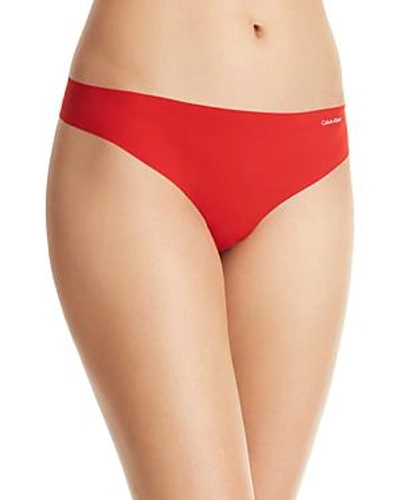 Shop Calvin Klein Invisibles Thong In Manic Red