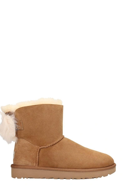 Shop Ugg Fluff Mini Bow Boots In Leather Color