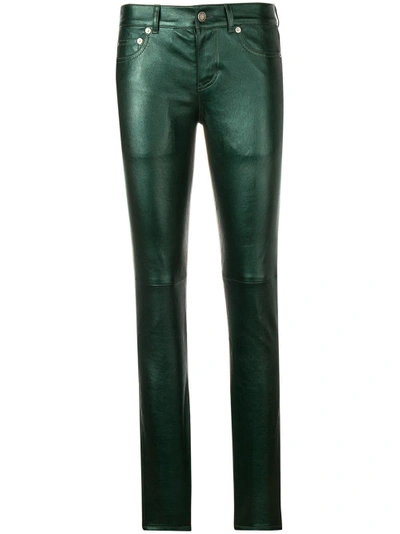 Shop Saint Laurent Coated Slim Fit Trousers In Green
