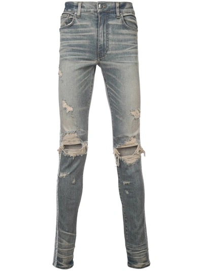 Shop Amiri Faded Distressed Skinny Jeans - Blue