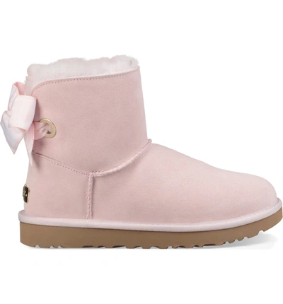 Shop Ugg Customizable Bailey Bow Mini Genuine Shearling Bootie In Seashell Pink Suede