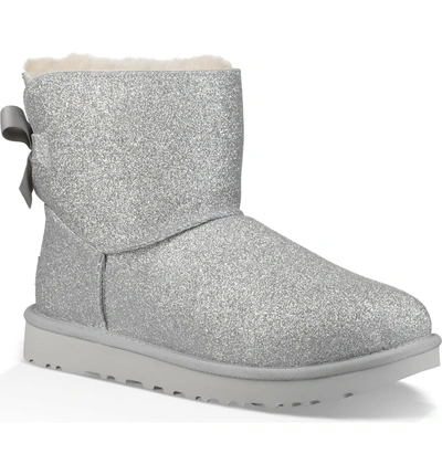 Shop Ugg Mini Bailey Bow Sparkle Genuine Shearling Boot In Silver