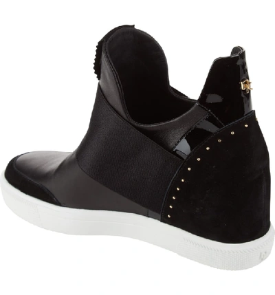 Shop Donna Karan Cailin Studded Wedge Sneaker In Black Leather