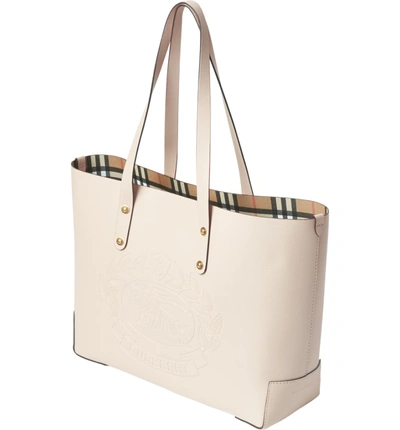 Shop Burberry Embossed Crest Small Leather Tote In Limestone