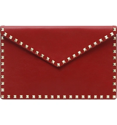 Shop Valentino Large Rockstud Leather Envelope Clutch - Red In Rubino