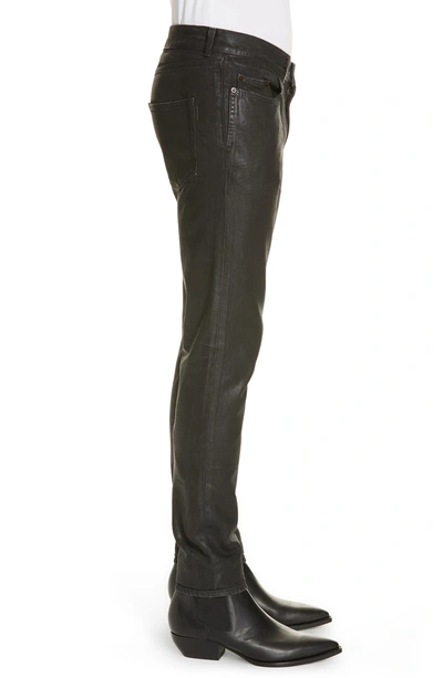 Shop Saint Laurent Wax Coated Skinny Jeans In Black