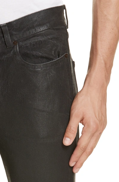 Shop Saint Laurent Wax Coated Skinny Jeans In Black